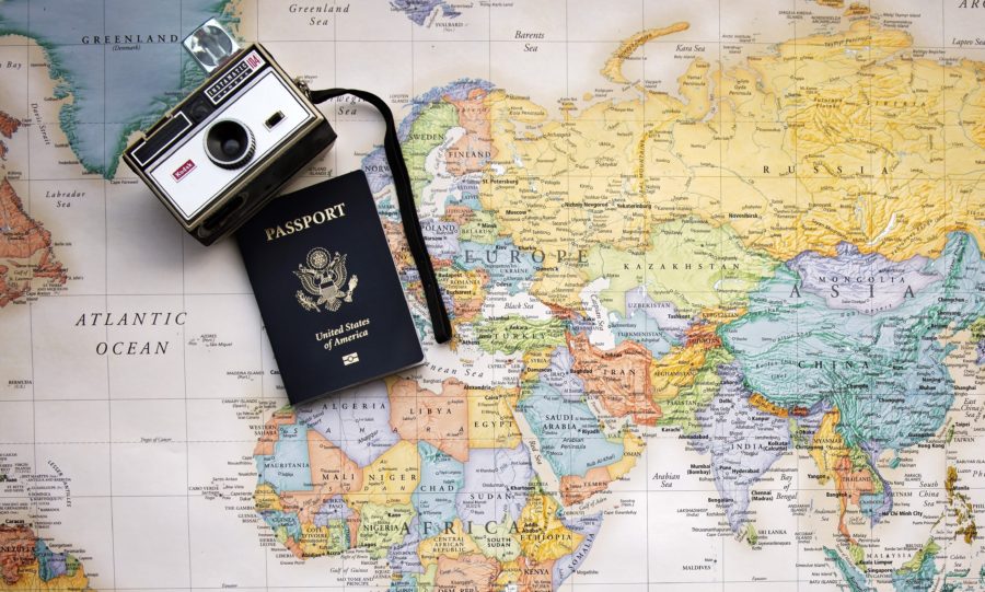 Retro camera and American passport on map