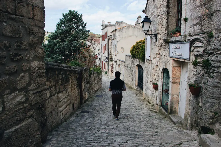 Man walking on cobblestone street