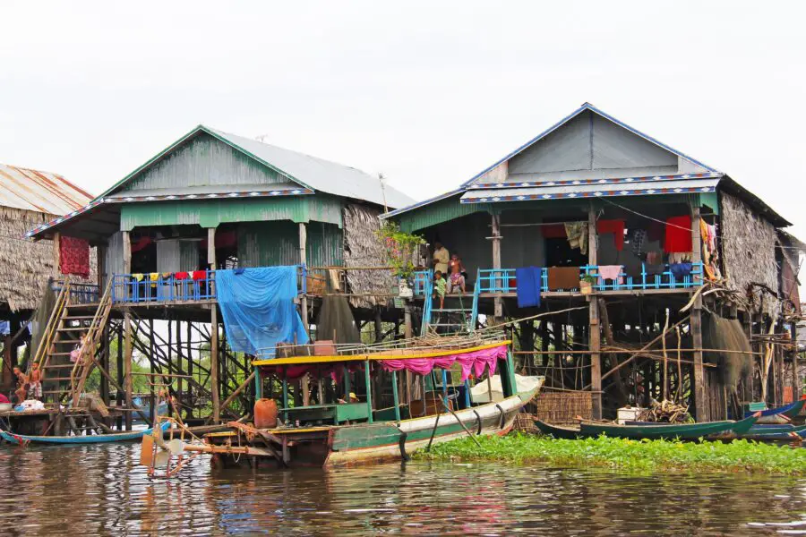 A couple of green houses and a few boats in the village of Kampong Phluk, one of the most popular floating villages on Tonle Sap Lake Cambodia