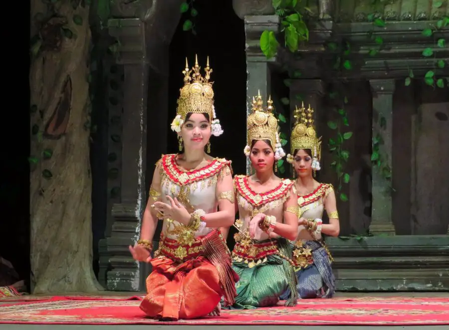 A few women in traditional clothing and a golden crown on stage of an Apsara Dance Performance in Siem Reap