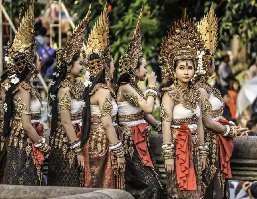 A group of 6 Apsara Dance Performers waiting beside a stage for a Siem Reap performance
