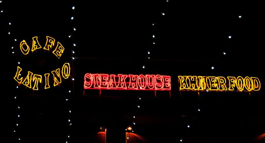 The yellow and red neon signs in Pub Street (the street with the best restaurants in Siem Reap), with the words "Khmer Food", "Steakhouse", and "Cafe Latino"