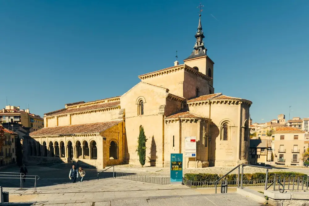 Photo of the muted San Millan Church (Iglesia de San Millan) surrounded by deep blue skies.