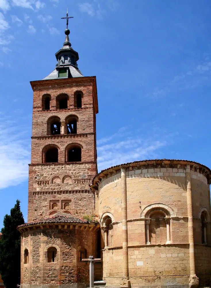 Photo of the side of the Church of San Martin (Iglesia de San Martin), with a close-up of its brick tower and sandstone base.