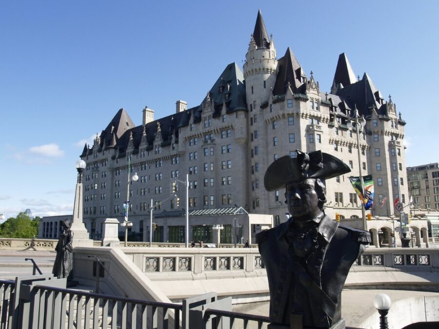 A statue in front of the Fairmont Chateau Laurier in Ottawa, one of the best luxury accommodations in Ottawa