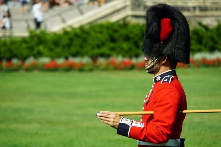 A guard on the grassy grounds of Parliament Hill on a sunny, summer day - one of the best things to do this summer in Ottawa