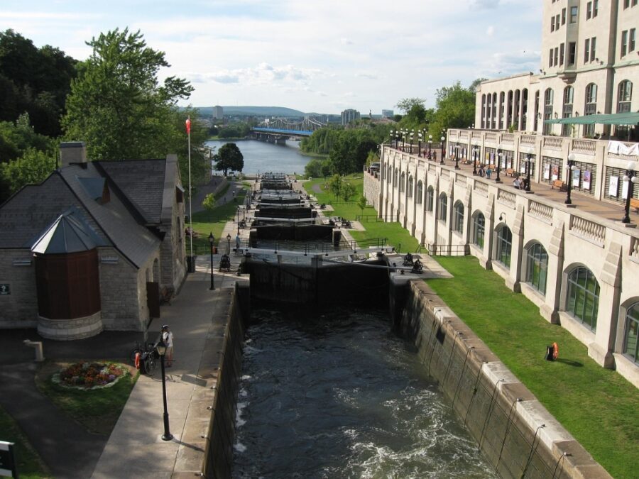 A view of the Rideau Canal Locks with the Ottawa River and the Alexandra Bridge in the back