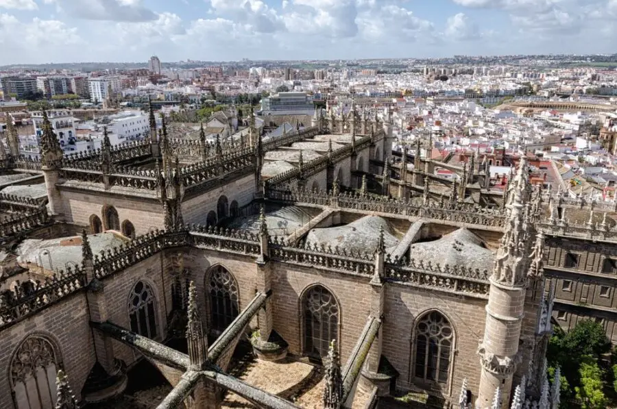 A view of the Seville Cathedral and the city of Seville from the Giralda Tower on a slightly cloudy day.
