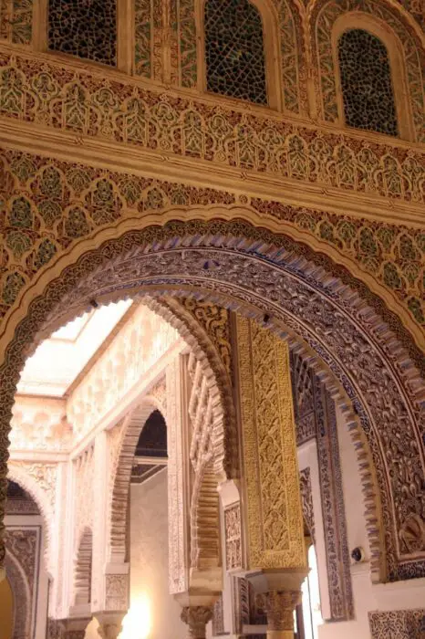The detailed and intricate details on the arches of the Alcazar de Sevilla.